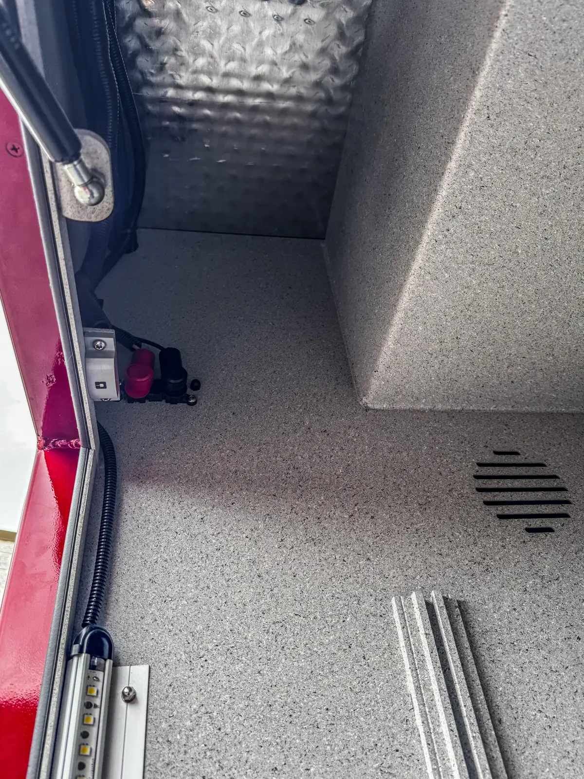 Lower slide-out tray pulled from side compartment with textured tray surface.